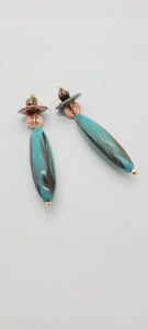 Length: 4 inches | Weight: 0.7 ounces  Distinctly You! These earrings are made with turquoise feathered hand painted oblong wood bead, copper and turquoise ceramic saucers, 8mm copper lentils, 6mm copper lava beads, and gold seed beads.