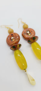 Length: 3.5 inches | Weight: 0.7 ounces  Distinctly You! These earrings are made with oblong citron glass beads, green and yellow wooden Bicone beads, orange bronze ceramic rondelles, 6mm gold ceramic stones, gold seed beads, gold hexagon, and gold charm.