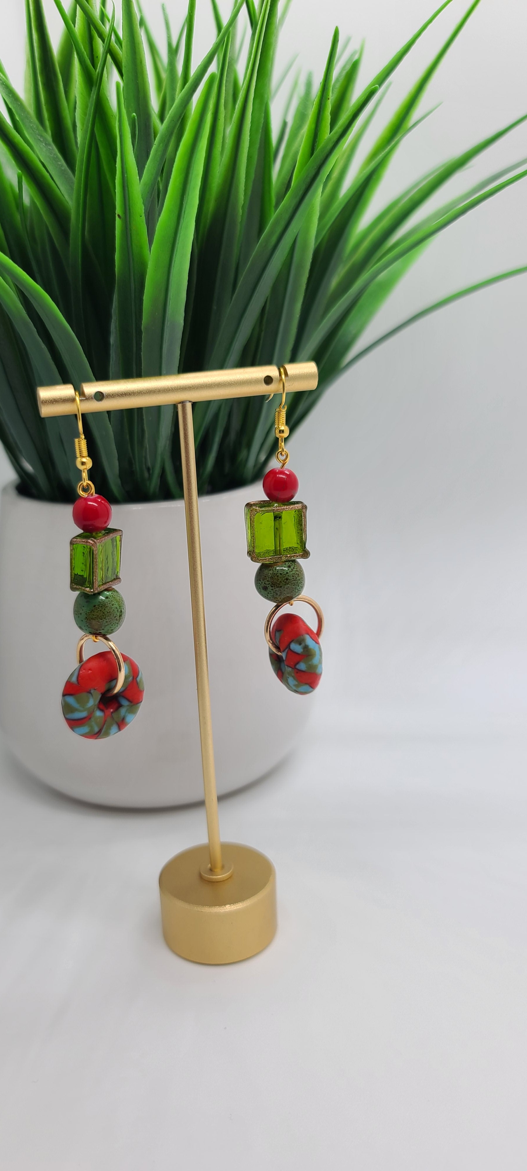 Length: 3 inches | Weight: 0.7 ounces  Distinctly You! These earrings are made with red and green Ashanti glass saucers, 12mm green ceramic stones, green and gold trim glass square box beads, 8mm red glass beads.
