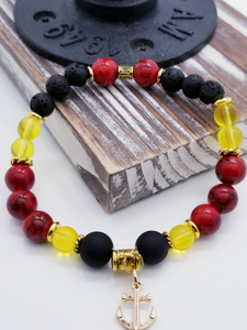 Honor, Courage, and Commitment (US Marine Corps values) inspired bracelet to honor our troops, veterans, and the families that support them! Anchor charm with matte black beads, red and black marble beads, yellow glass beads, matte gold metallic beads, black and white marbled beads, gold faceted spacer bead, and gold spacers. 