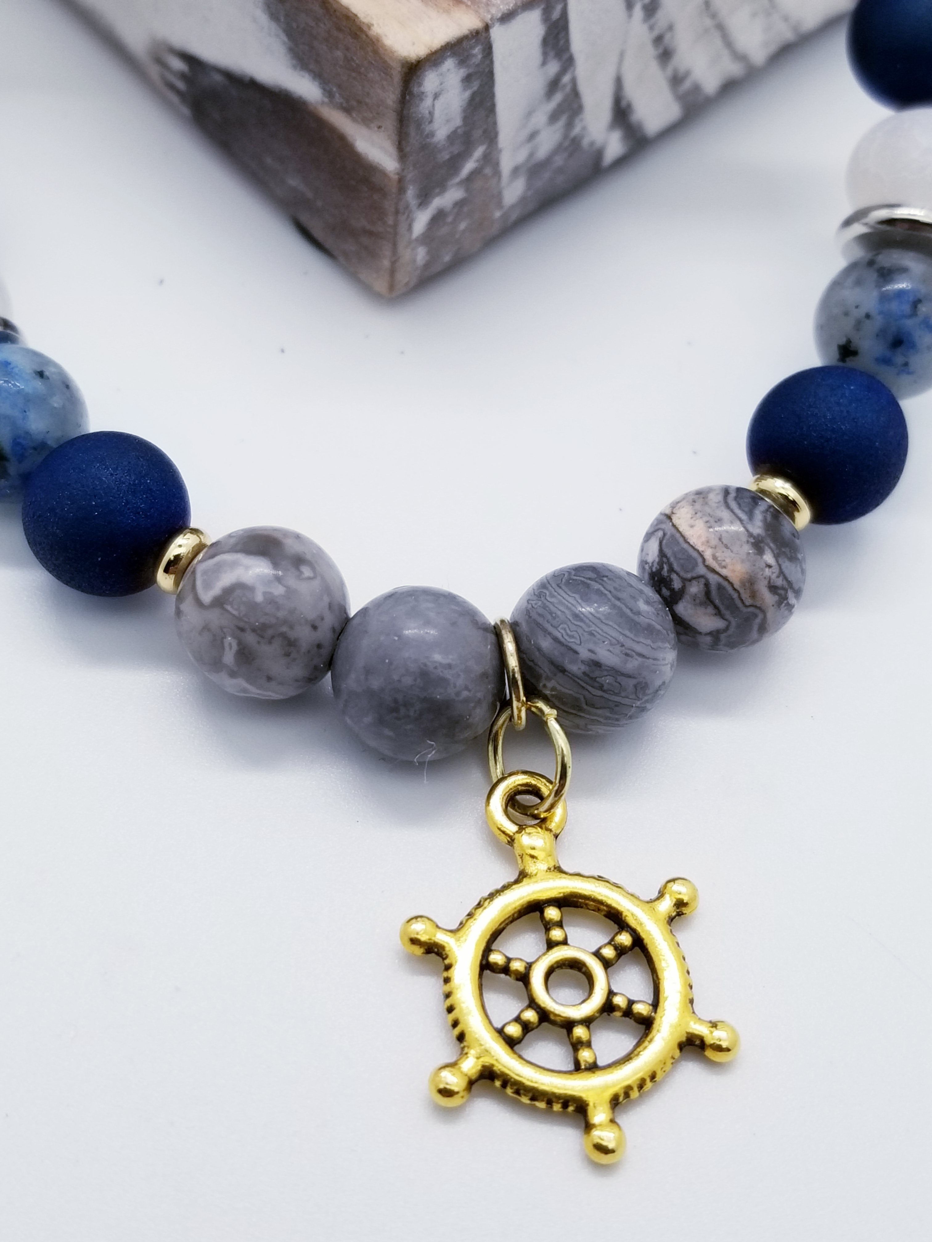 Honor, Respect, and Duty (US Coast Guard core values) inspired bracelet to honor our troops, veterans, and the families that support them! Ship wheel charm with white turquoise beads, grey marbled glass beads, sky blue glass beads, cracked blue and white beads, and gold spacers. 
