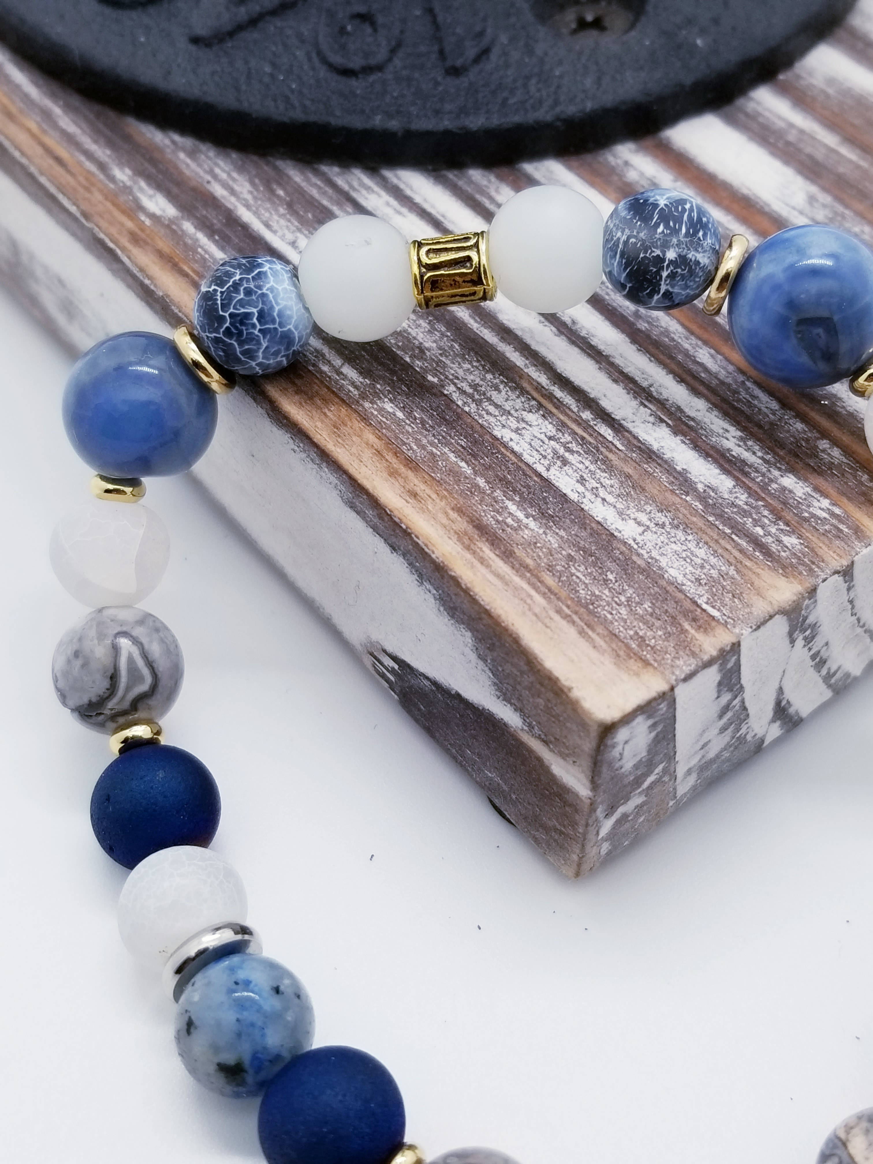 Honor, Respect, and Duty (US Coast Guard core values) inspired bracelet to honor our troops, veterans, and the families that support them! Ship wheel charm with white turquoise beads, grey marbled glass beads, sky blue glass beads, cracked blue and white beads, and gold spacers. 