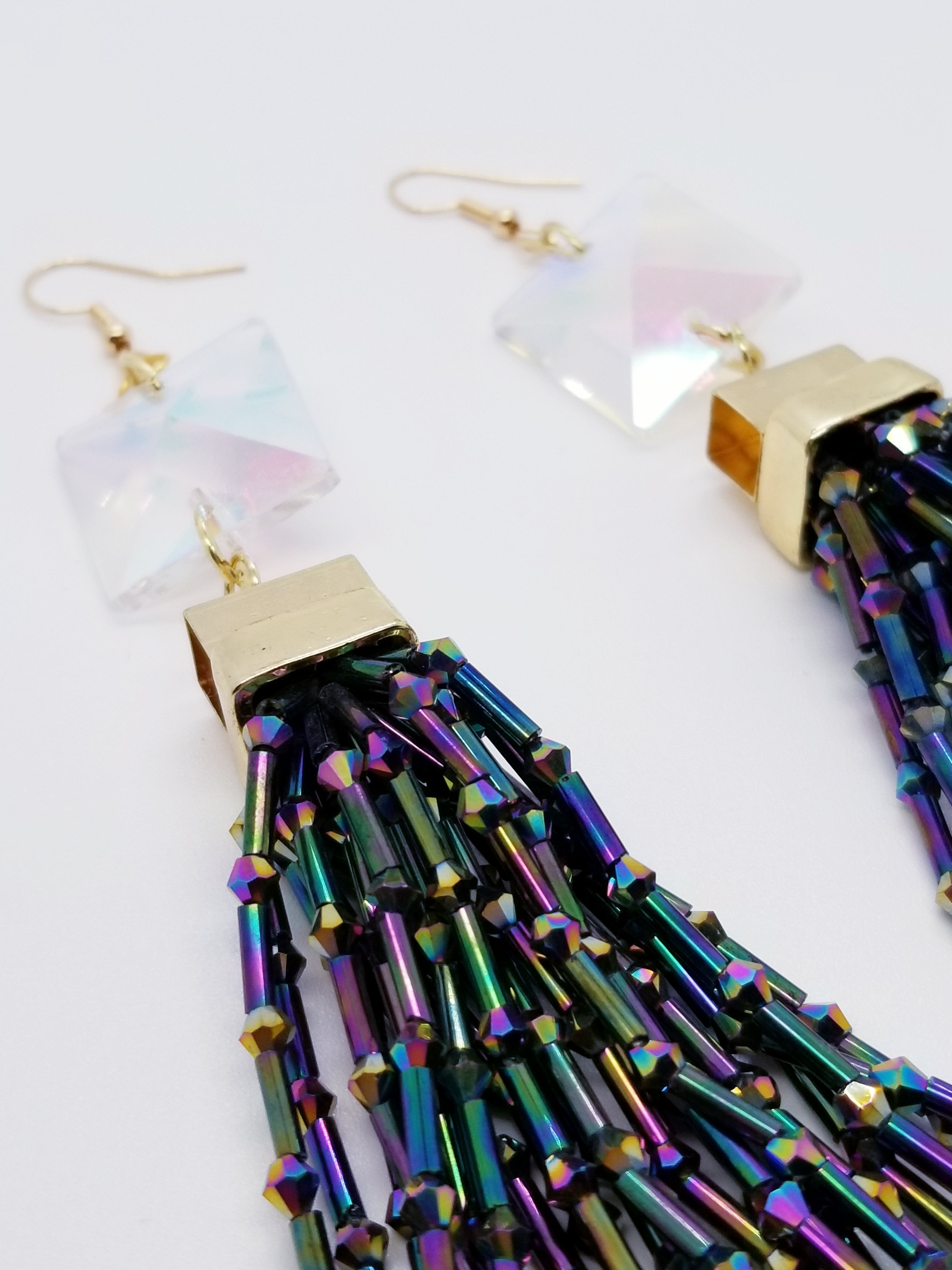 PLEASE BE AWARE: Earrings Hang Past Shoulders   Length: 5.5 inches | Weight: 1.4 ounces  Distinctly You! The earrings are handmade using iridescent square crystal stone beads, iridescent glass tassels, and hypoallergenic hooks with back closures. 