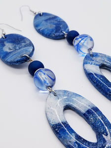 PLEASE BE AWARE: Earrings Hang Past Shoulders   Length: 5.5 inches | Weight: 1 ounce  Distinctly You! The earrings are handmade using blue and silver swirl polymer clay design with resin overlay, 12mm blue swirl glass beads, 10mm blue Druzy Agate beads, silver rondelle spacers, silver head pins, and hypoallergenic hooks with back closures. 