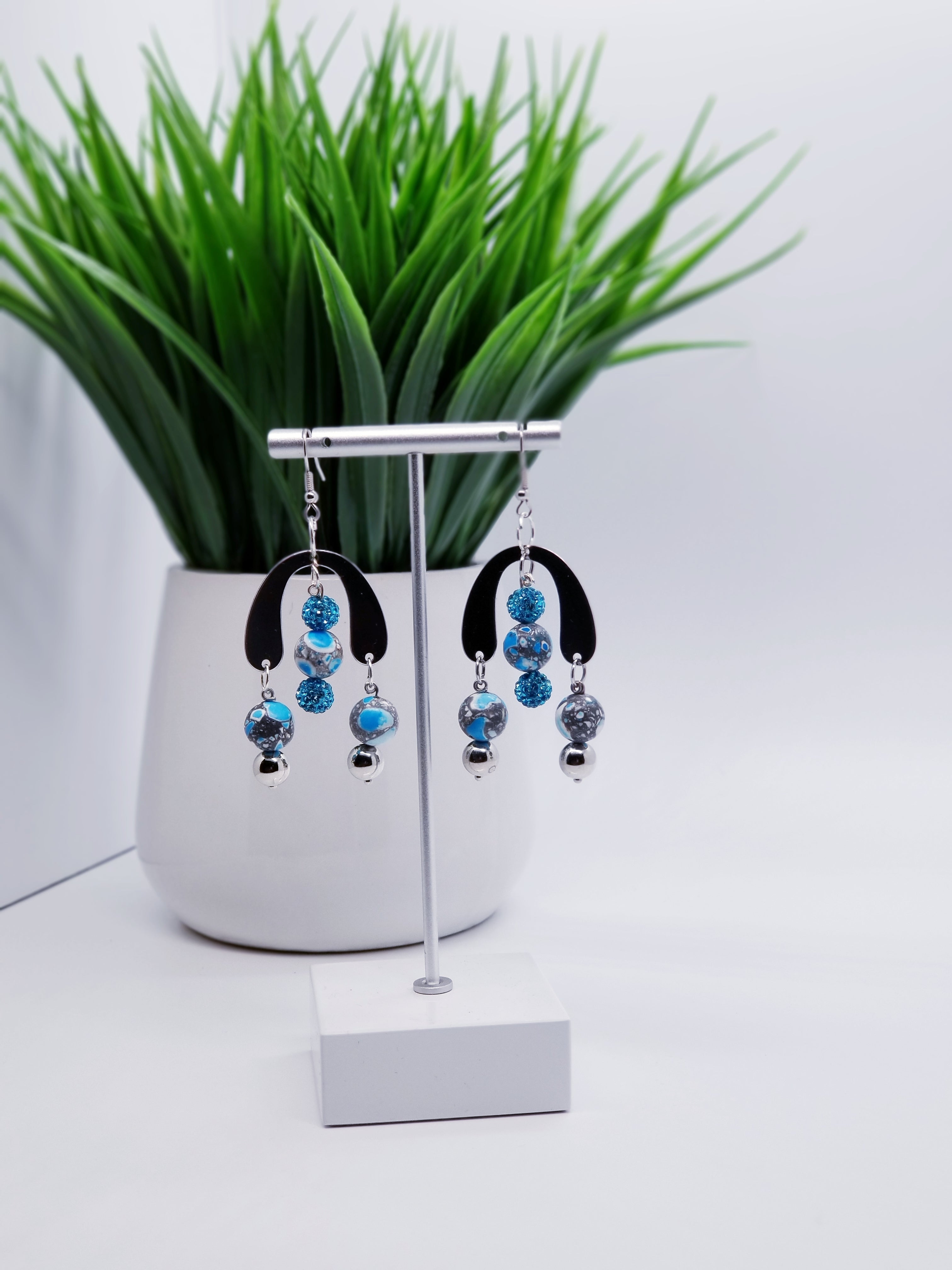 Length: 3 inches | Weight: 0.6 ounces  Designed just for you! The earrings are handmade using speckled black and aqua matte beads, aqua pave ball spacers, silver u-shaped charm, silver metal beads, silver head pins, and hypoallergenic hooks with back closures. 