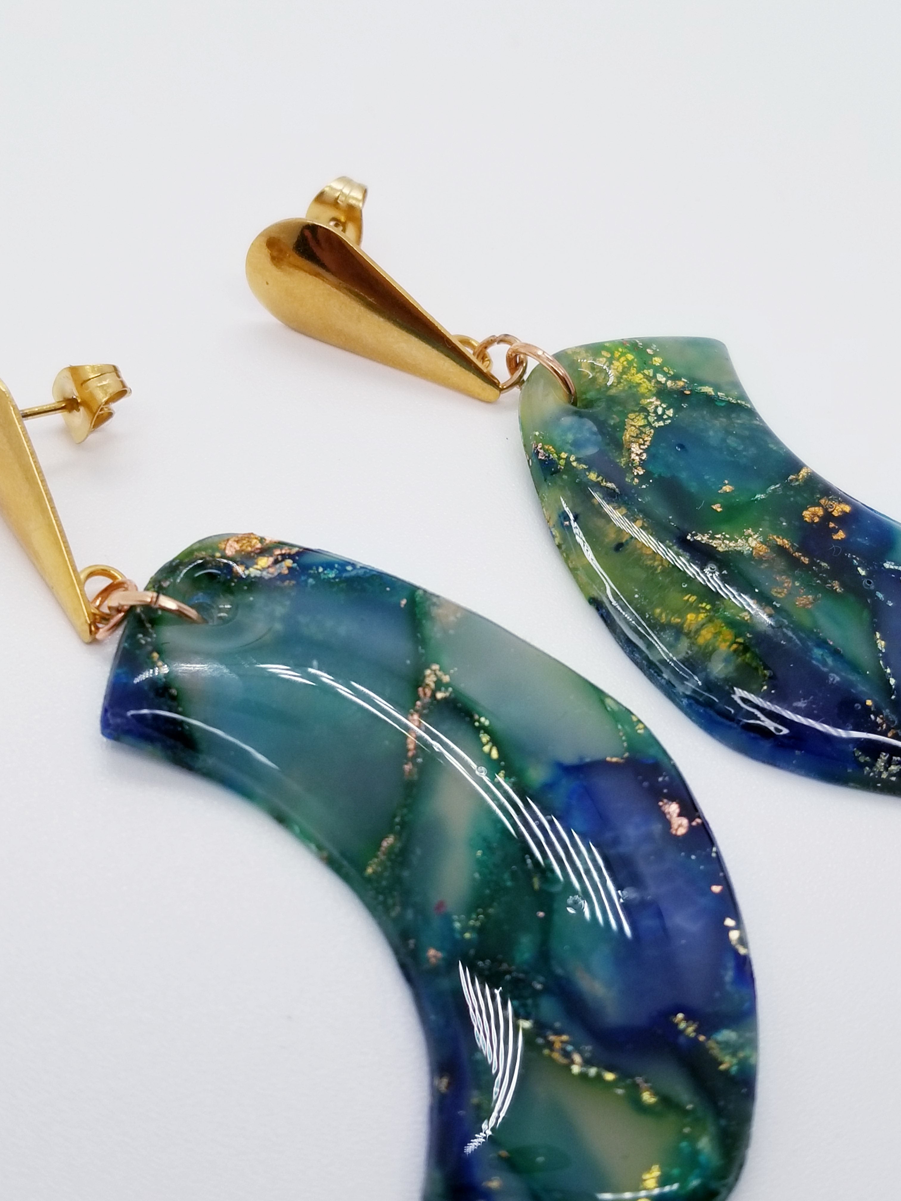 Length: 3 inches | Weight: 0.6 ounces  Designed just for you! The earrings are handmade using green blue swirl gold resin design, gold charm with hypoallergenic posts with back closures.
