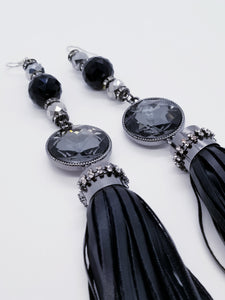 PLEASE BE AWARE: Earrings Hang Past Shoulders  5.5 inches or more  Length: 8 inches | Weight: 2.1 ounces (earlobe supports provided due to weight)  Designed just for you! The earrings are handmade using black faux bejeweled tassel, 14mm black faceted glass beads, 4mm black rhinestone rondels, 8mm silver faceted glass beads, and hypoallergenic hooks with back closures. 