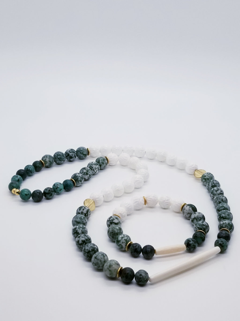 Bracelet: Length- 7.75 inches | Weight: 1.5 ounces  Necklace: Length- 30 inches | 5.2 ounces  Distinctly You! This necklace and bracelet set is handmade using 12mm green and cream speckled matte beads, 12mm white lotus beads, 10mm green speckled beads, brass gold spacers, white hair bone spacer, necklace uses metal cord, and bracelet uses 8mm latex free clear stretch cord.
