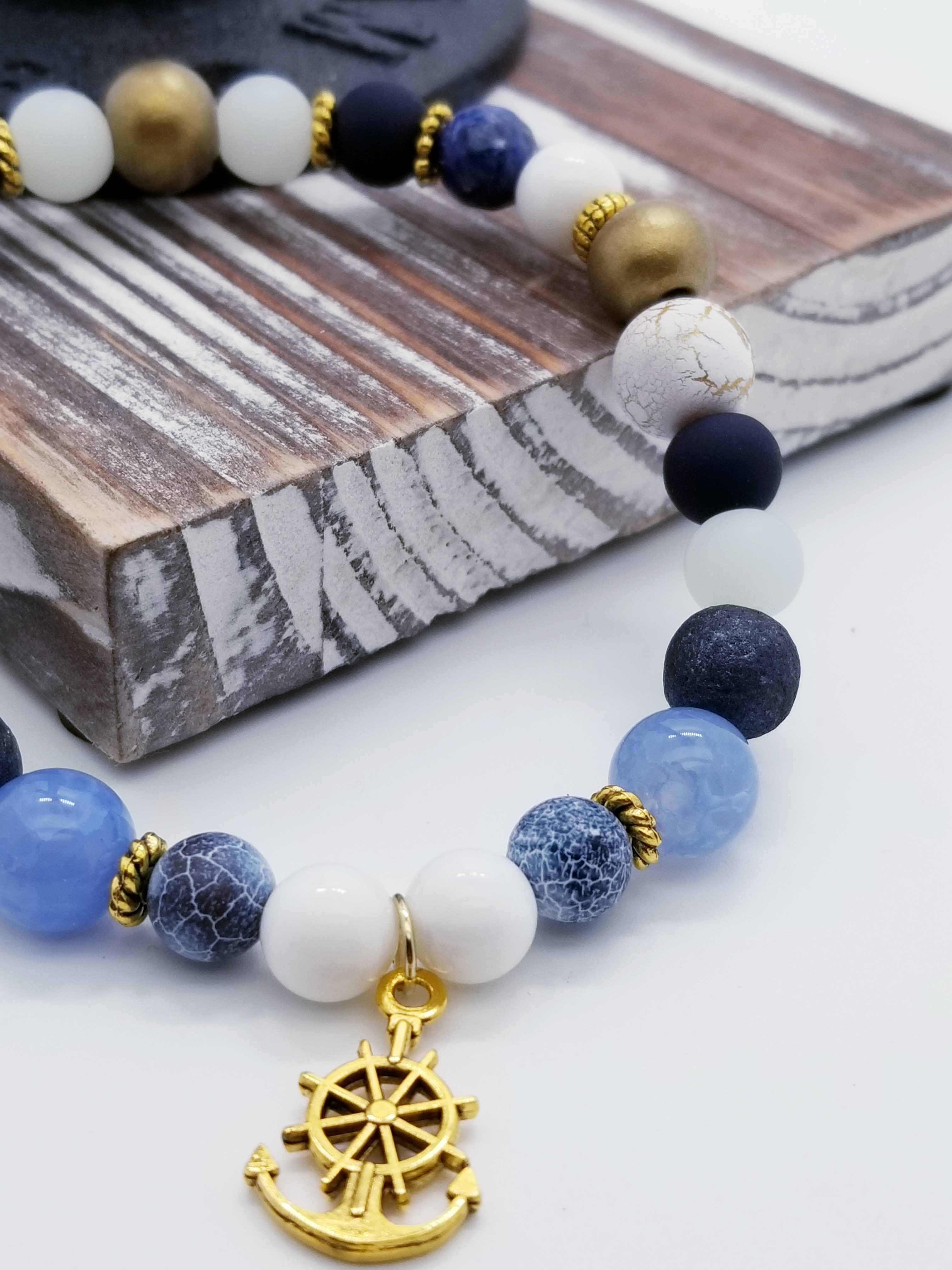 Honor, Courage, and Commitment (US Navy core values) inspired bracelet to honor our troops, veterans, and the families that support them! Anchor charm with white turquoise beads, indigo and navy marbled beads, gold and white marbled beads, navy matte glass beads, sky blue glass beads, gold faceted spacer beads, and gold spacers. 