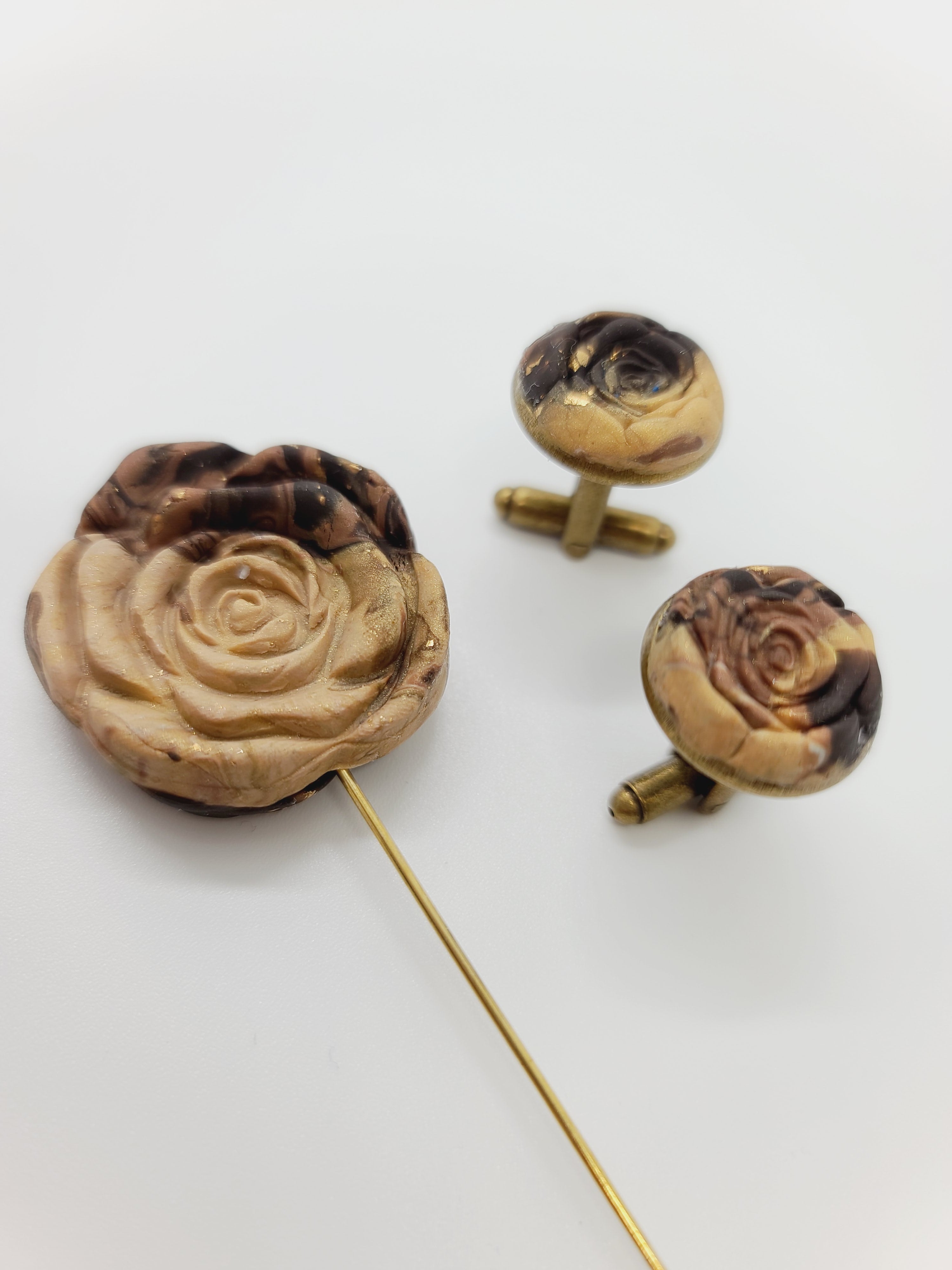 Distinctly You! These were part of our summer Pop Up Shop line and are now available here on our website. Handmade cufflinks and lapel pin using brown polymer clay with gold flake, brass lapel pin, and brass cufflinks.