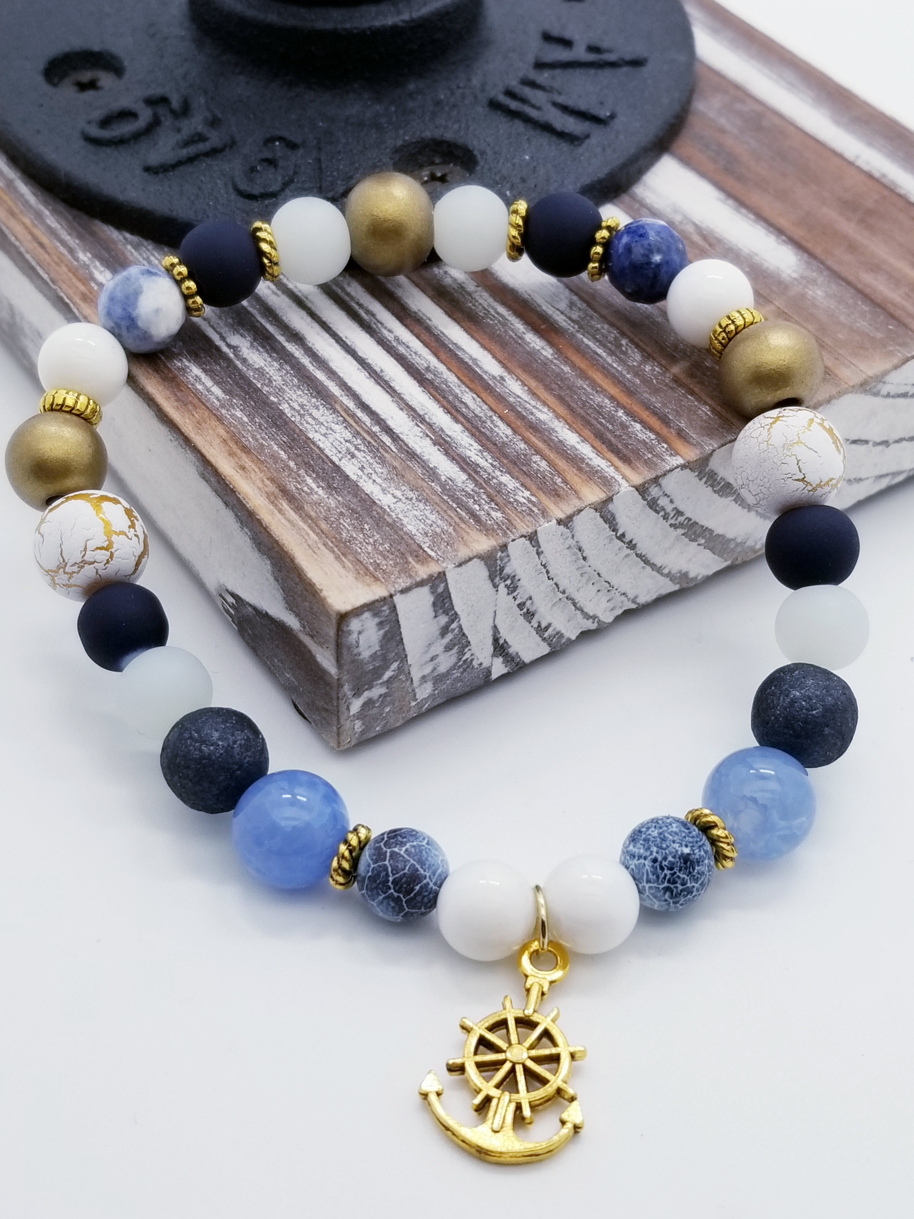 Honor, Courage, and Commitment (US Navy core values) inspired bracelet to honor our troops, veterans, and the families that support them! Anchor charm with white turquoise beads, indigo and navy marbled beads, gold and white marbled beads, navy matte glass beads, sky blue glass beads, gold faceted spacer beads, and gold spacers. 