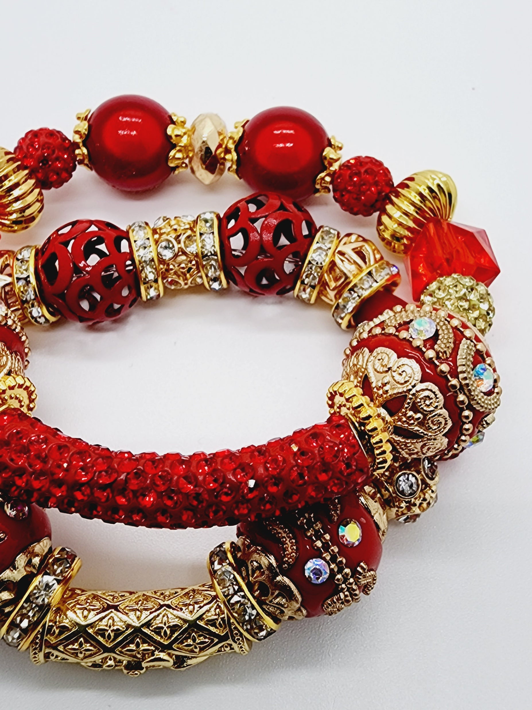 Length: 7.75 inches | Weight: 2.7 ounces  Distinctly You! This bracelet set is handmade using red and gold and ornate bead mix, gold rhinestone rondelle spacers, and bracelet uses 8mm latex free clear stretch cord. 