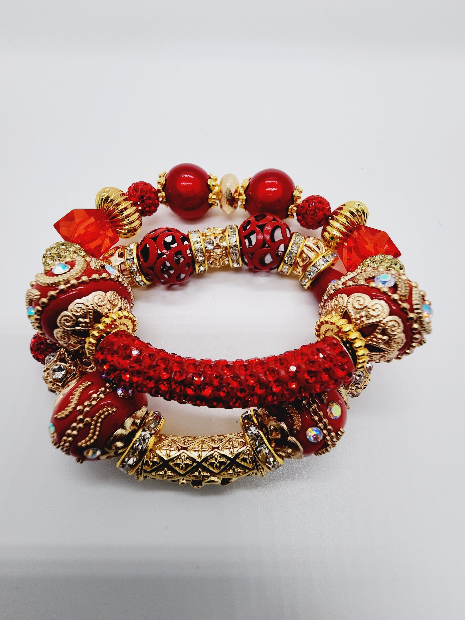 Length: 7.75 inches | Weight: 2.7 ounces  Distinctly You! This bracelet set is handmade using red and gold and ornate bead mix, gold rhinestone rondelle spacers, and bracelet uses 8mm latex free clear stretch cord. 