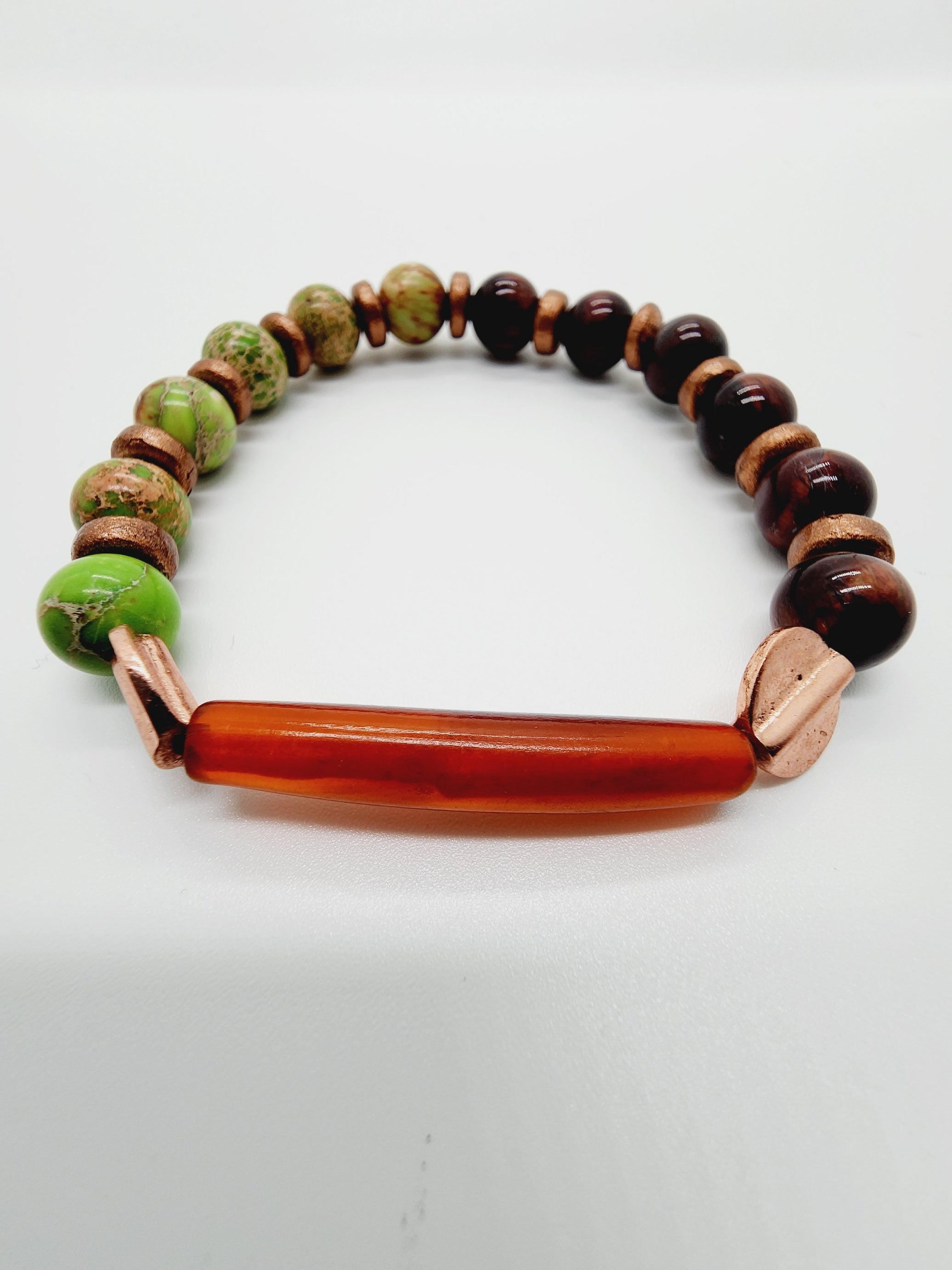 Length: 7.75 inches | Weight: 0.8 ounces  Distinctly You! This bracelet is handmade using Amber pipe bead and tiger eye beads, and bracelet uses 8mm latex free clear stretch cord. 