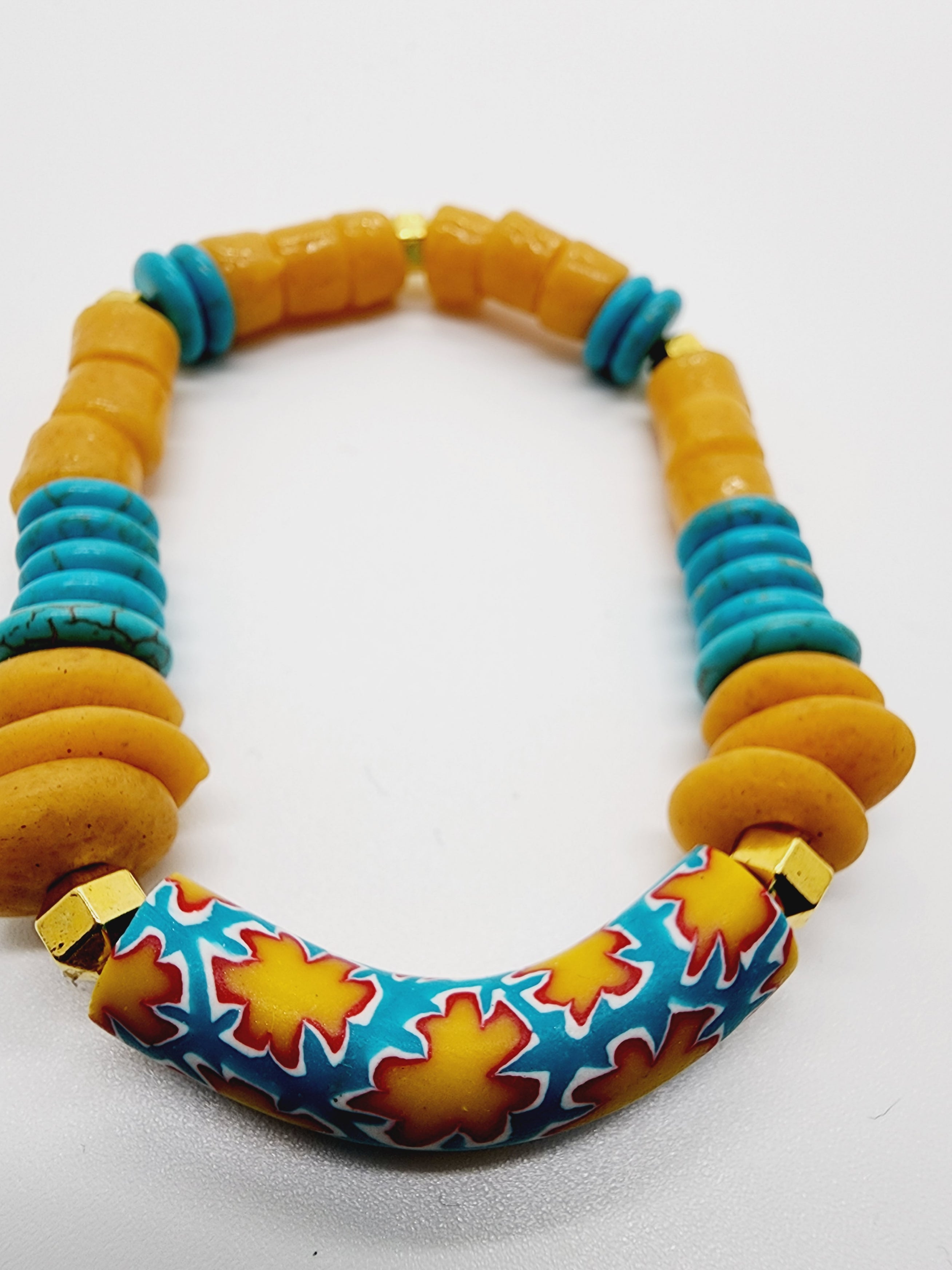 Length: 7.75 inches | Weight: 1.1 ounces  Distinctly You! This bracelet is handmade using gold Kente beads, turquoise resin spacers, gold spacer beads, and bracelet uses 8mm latex free clear stretch cord. 