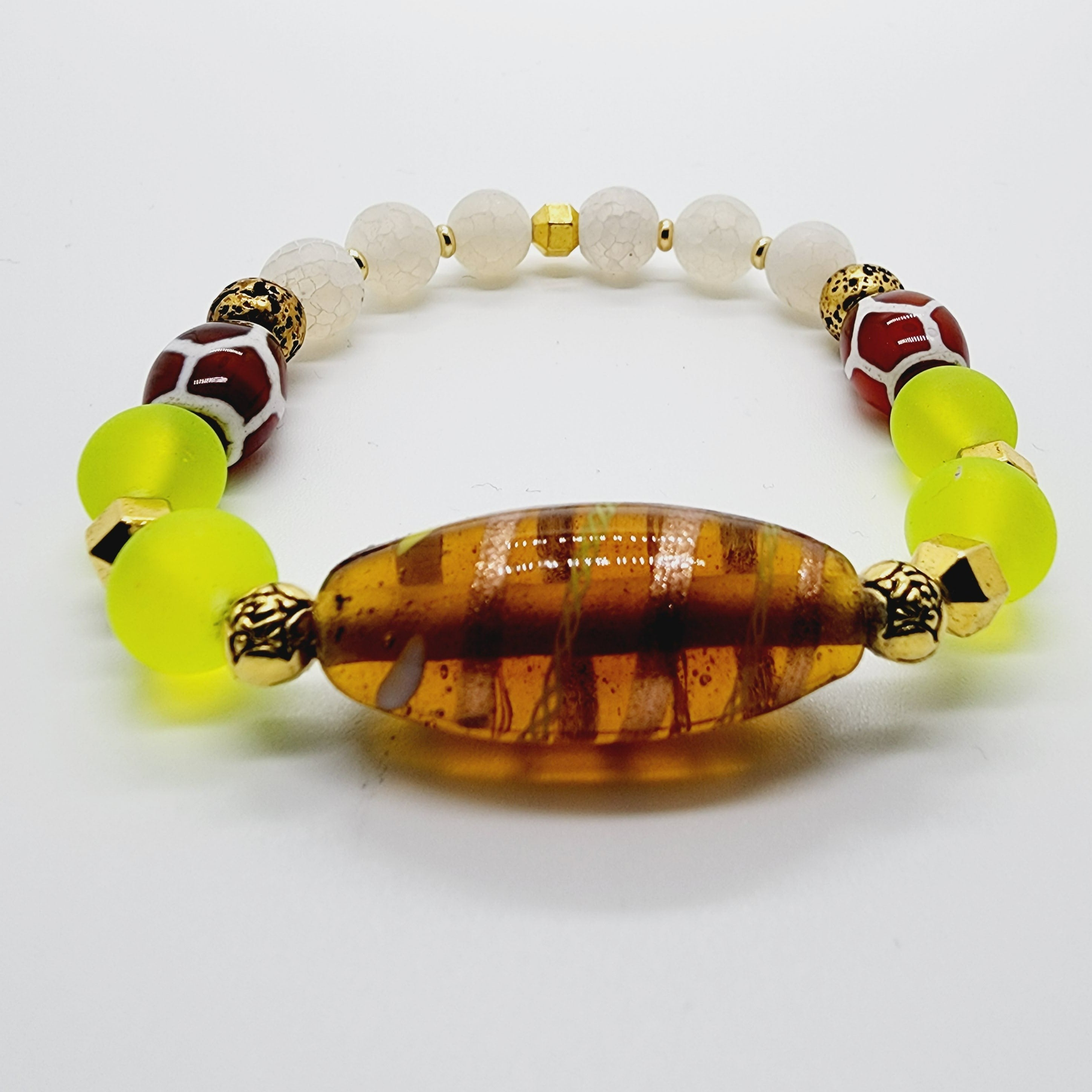 Length: 7.5 inches | Weight: 1.1 ounces  Distinctly You! This bracelet is handmade using citron beads, tan and white beads, and, frosted crackle beads, lamp post spacers, and bracelet uses 8mm latex free clear stretch cord. 
