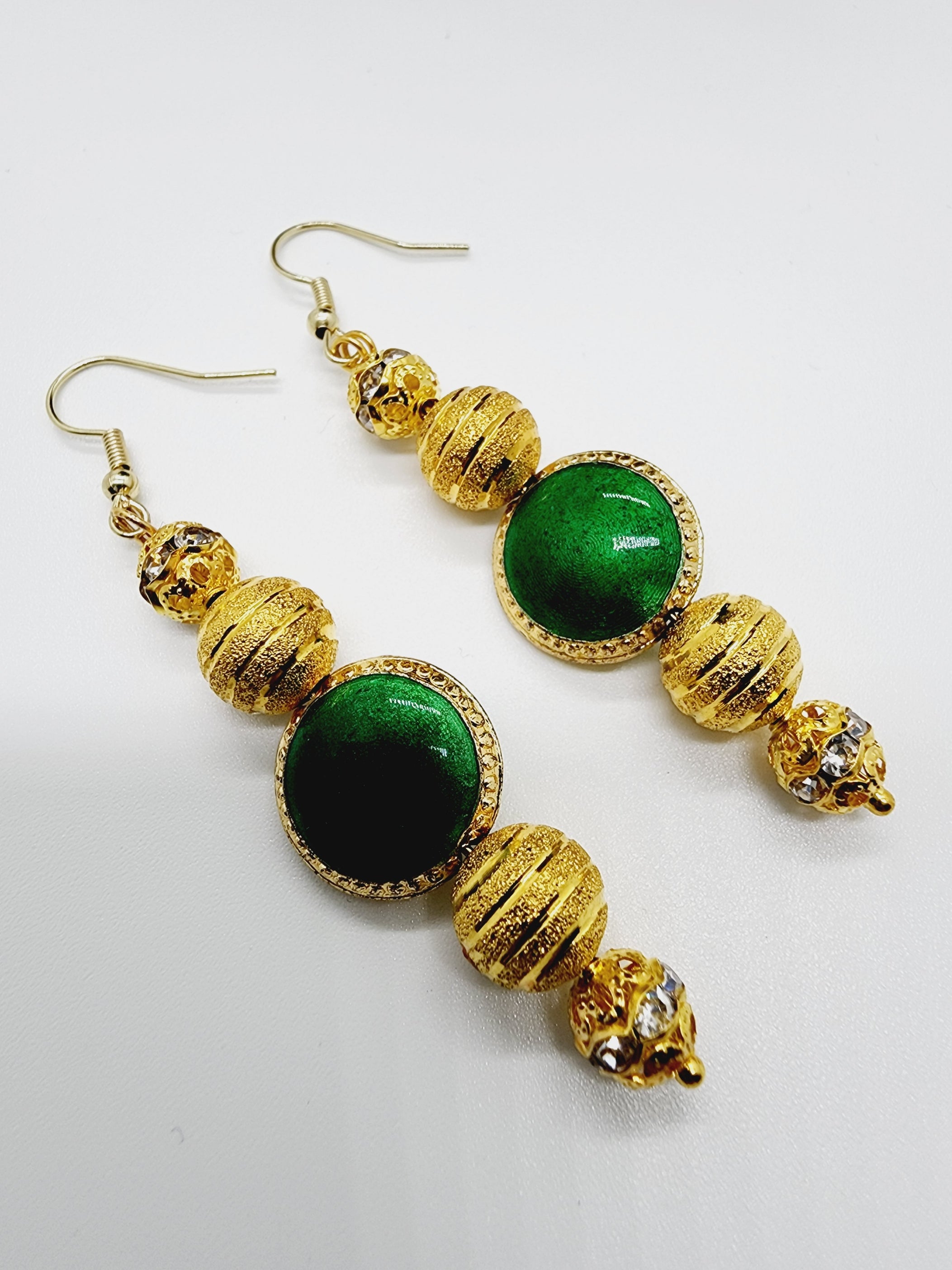 Length: 2.75 inches | Weight: 0.3 ounces  Distinctly You! These handmade earrings are made using gold inlaid rhinestone beads, striped gold bead plated and green glass bead, and hypoallergenic hooks with back closures.  