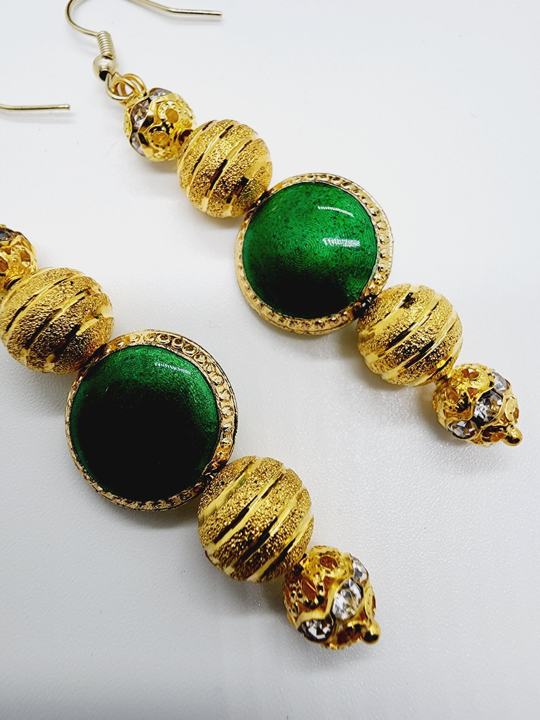Length: 2.75 inches | Weight: 0.3 ounces  Distinctly You! These handmade earrings are made using gold inlaid rhinestone beads, striped gold bead plated and green glass bead, and hypoallergenic hooks with back closures.  
