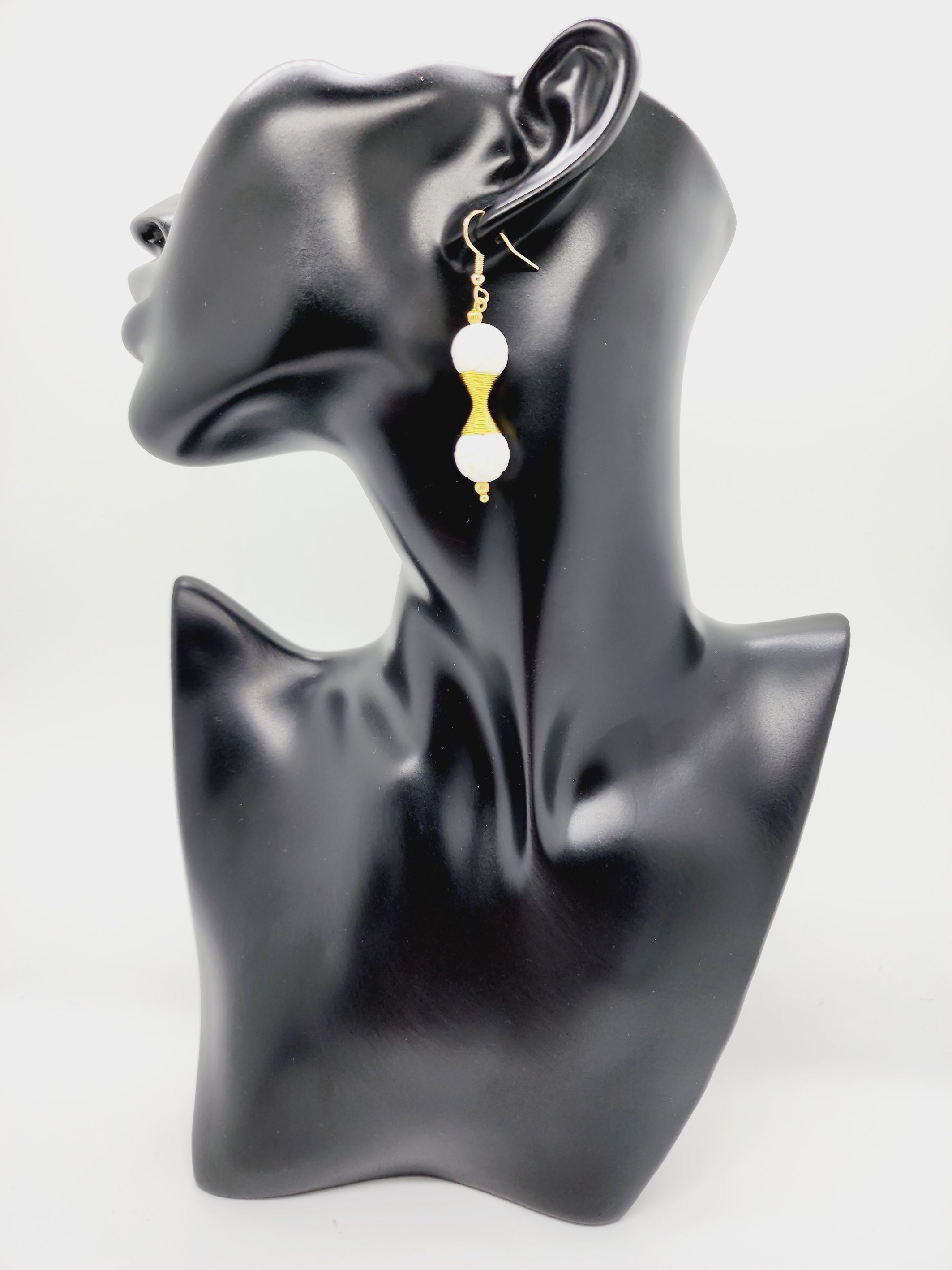 Length: 2 inches | Weight: 0.4 ounces  Distinctly You! These handmade earrings are made using 12mm carved white ceramic beads, gold charm double spring, 2mm gold ribbed seed bead, and hypoallergenic hooks with back closures.  