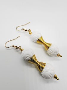 Length: 2 inches | Weight: 0.4 ounces  Distinctly You! These handmade earrings are made using 12mm carved white ceramic beads, gold charm double spring, 2mm gold ribbed seed bead, and hypoallergenic hooks with back closures.  