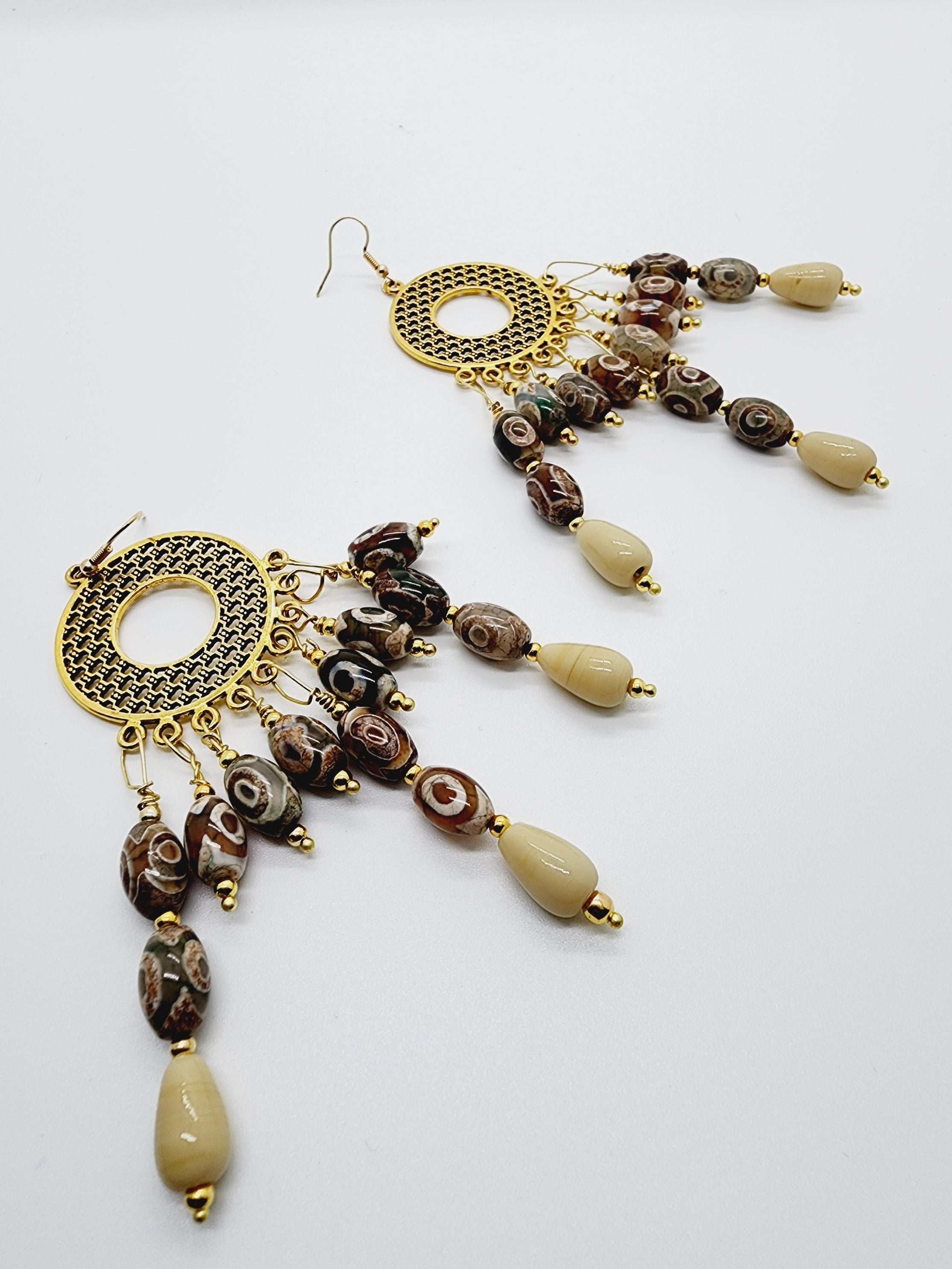 Length: 5 inches | Weight: 1.8 ounces  Distinctly You! These handmade earrings are made using gold circular weaved charm, ceramic beads, ivory ceramic beads, 2mm gold seed beads, and hypoallergenic hooks with back closures. 
