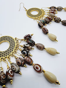 Length: 5 inches | Weight: 1.8 ounces  Distinctly You! These handmade earrings are made using gold circular weaved charm, ceramic beads, ivory ceramic beads, 2mm gold seed beads, and hypoallergenic hooks with back closures. 
