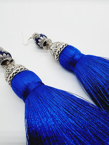 PLEASE BE AWARE: Earrings Hang Past Shoulders  5.5 inches or more  Length: 6 inches | Weight: 3.1 ounces (earlobe supports provided due to weight)  Distinctly You! These handmade earrings are made using silver and filigree beads, silver spacer, silver dome covers, cobalt blue silk tassels, and hypoallergenic hooks with back closures. 