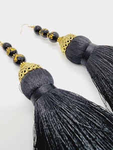 PLEASE BE AWARE: Earrings Hang Past Shoulders  5.5 inches or more  Length: 6 inches | Weight: 2.7 ounces (earlobe supports provided due to weight)  Distinctly You! These handmade earrings are made using gold and filigree beads, gold and black dragon beads, gold dome covers, black silk tassels. and hypoallergenic hooks with back closures. 