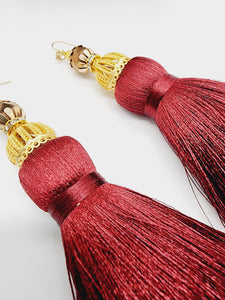 PLEASE BE AWARE: Earrings Hang Past Shoulders  5.5 inches or more  Length: 5.5 inches | Weight: 2.4 ounces (earlobe supports provided due to weight)  Distinctly You! These handmade earrings are made using gold and filigree beads, faceted gold beads, gold dome covers, burgundy wine silk tassels, and hypoallergenic hooks with back closures. 