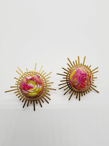 Length: 2 inches | Weight: 0.5 ounces   Distinctly You! These handmade earrings are made using pink and green floral stud, brass sunburst charm. and hypoallergenic hooks with back closures. 