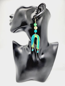 Length: 4.5 inches | Weight: 0.6 ounces   Distinctly You! These handmade earrings are made using lime green and teal swirl polymer clay, U-shaped charm, and hypoallergenic hooks with back closures. 