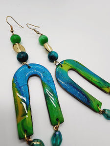 Length: 4.5 inches | Weight: 0.6 ounces   Distinctly You! These handmade earrings are made using lime green and teal swirl polymer clay, U-shaped charm, and hypoallergenic hooks with back closures. 