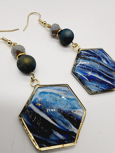 Length: 3 inches | Weight: 0.5 ounces   Distinctly You! These handmade earrings are made using blue and gold swirl polymer clay, gold hexagon frame, and hypoallergenic hooks with back closures. 