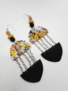 Length: 5.5 inches | Weight: 1.1 ounces   Distinctly You! These handmade earrings are made using orange, yellow, black and grey swirl polymer clay, silver chain, and hypoallergenic hooks with back closures. 