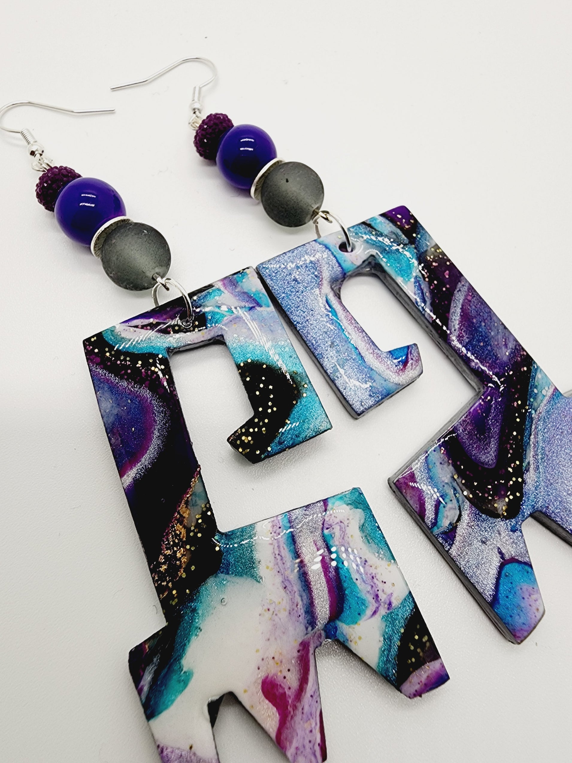 Length: 4.5 inches | Weight: 0.8 ounces   Distinctly You! These handmade earrings are made using purple and turquoise multi colored polymer clay, silver disc charm, purple rondelle spacers, and hypoallergenic hooks with back closures. 