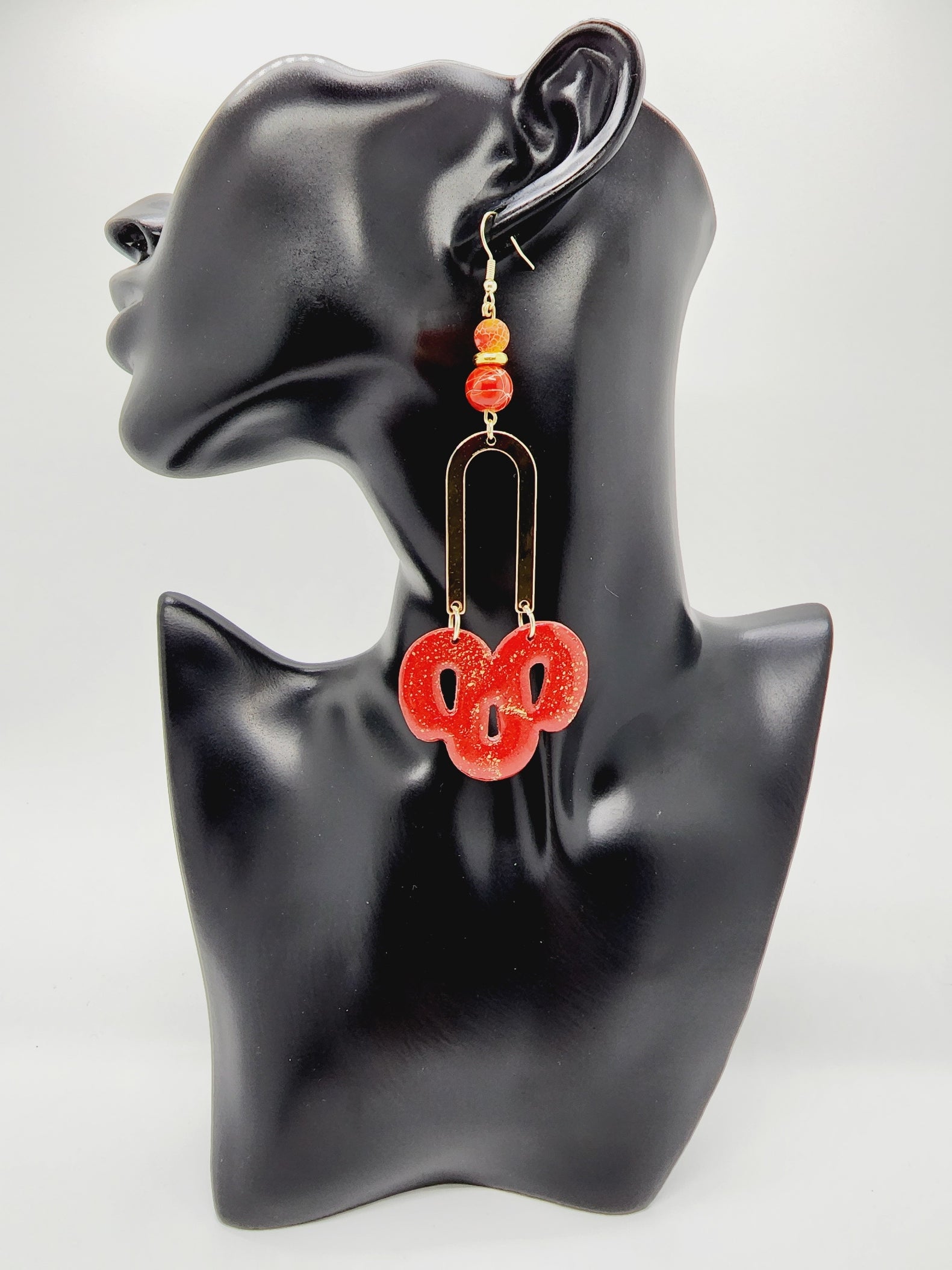 Length: 3.5 inches | Weight: 0.6 ounces   Distinctly You! These handmade earrings are made using red and gold polymer clay, red swirl beads, and hypoallergenic hooks with back closures. 