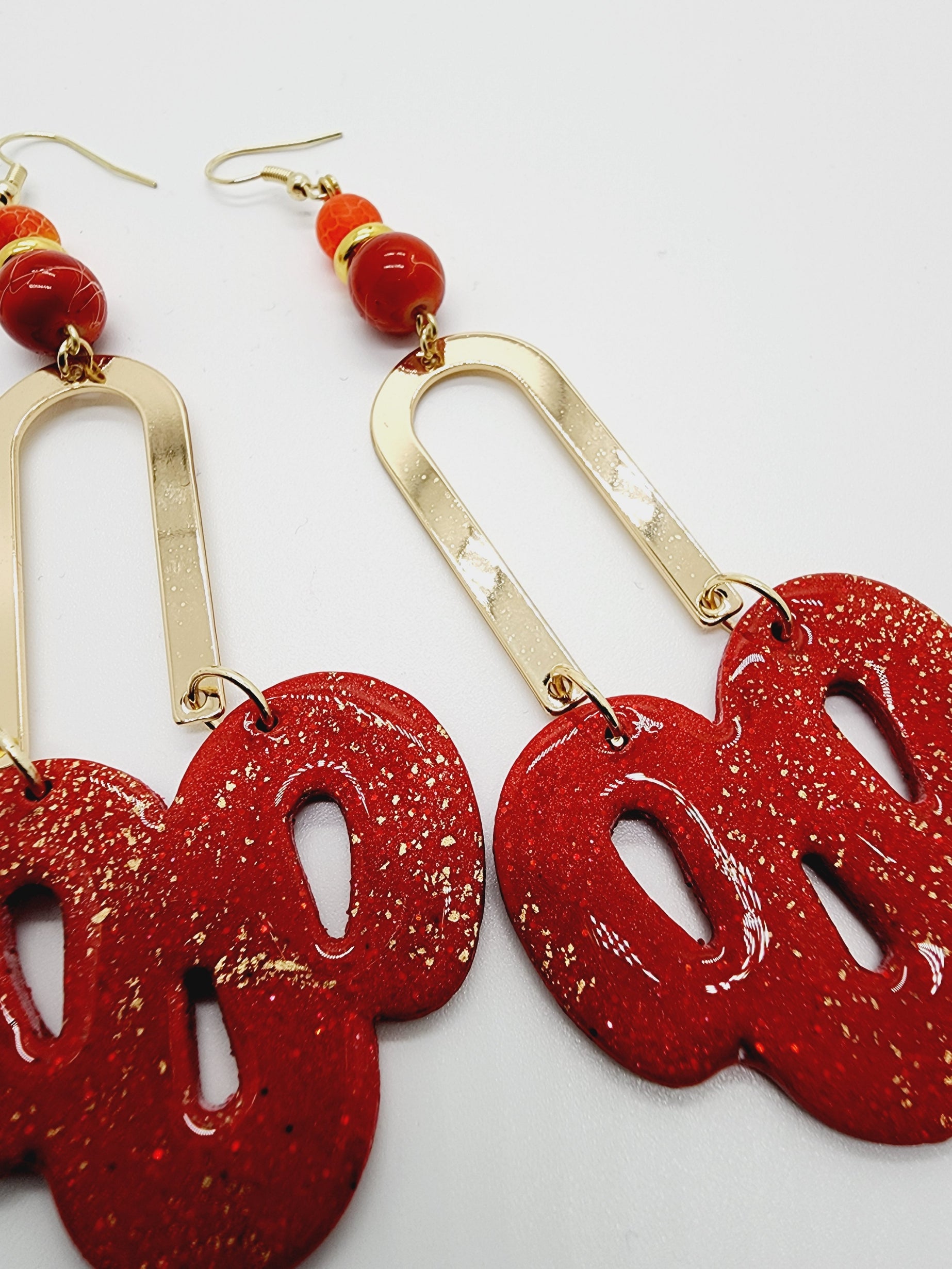 Length: 3.5 inches | Weight: 0.6 ounces   Distinctly You! These handmade earrings are made using red and gold polymer clay, red swirl beads, and hypoallergenic hooks with back closures. 