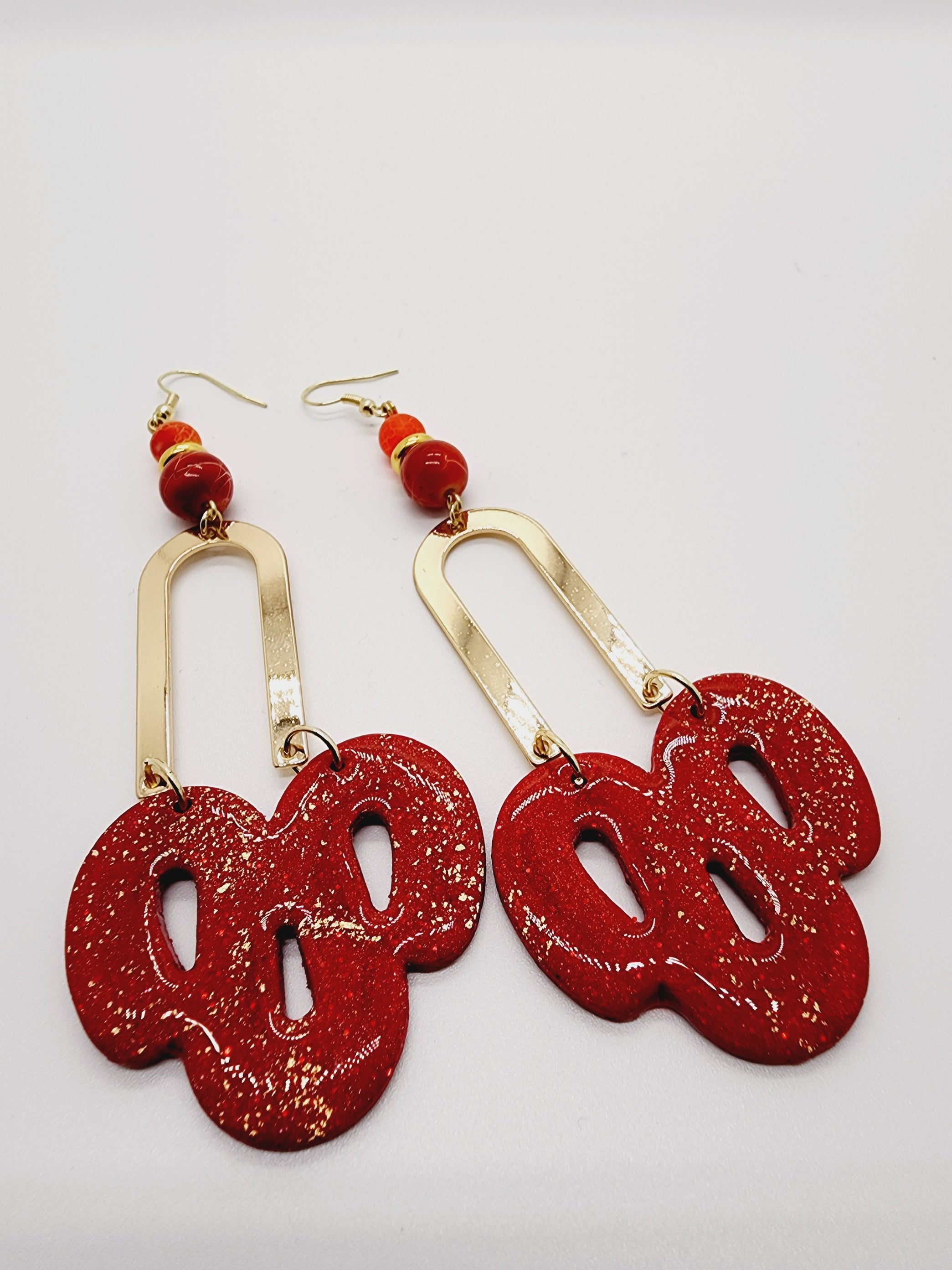Length: 3.5 inches | Weight: 0.6 ounces   Distinctly You! These handmade earrings are made using red and gold polymer clay, red swirl beads, and hypoallergenic hooks with back closures. 