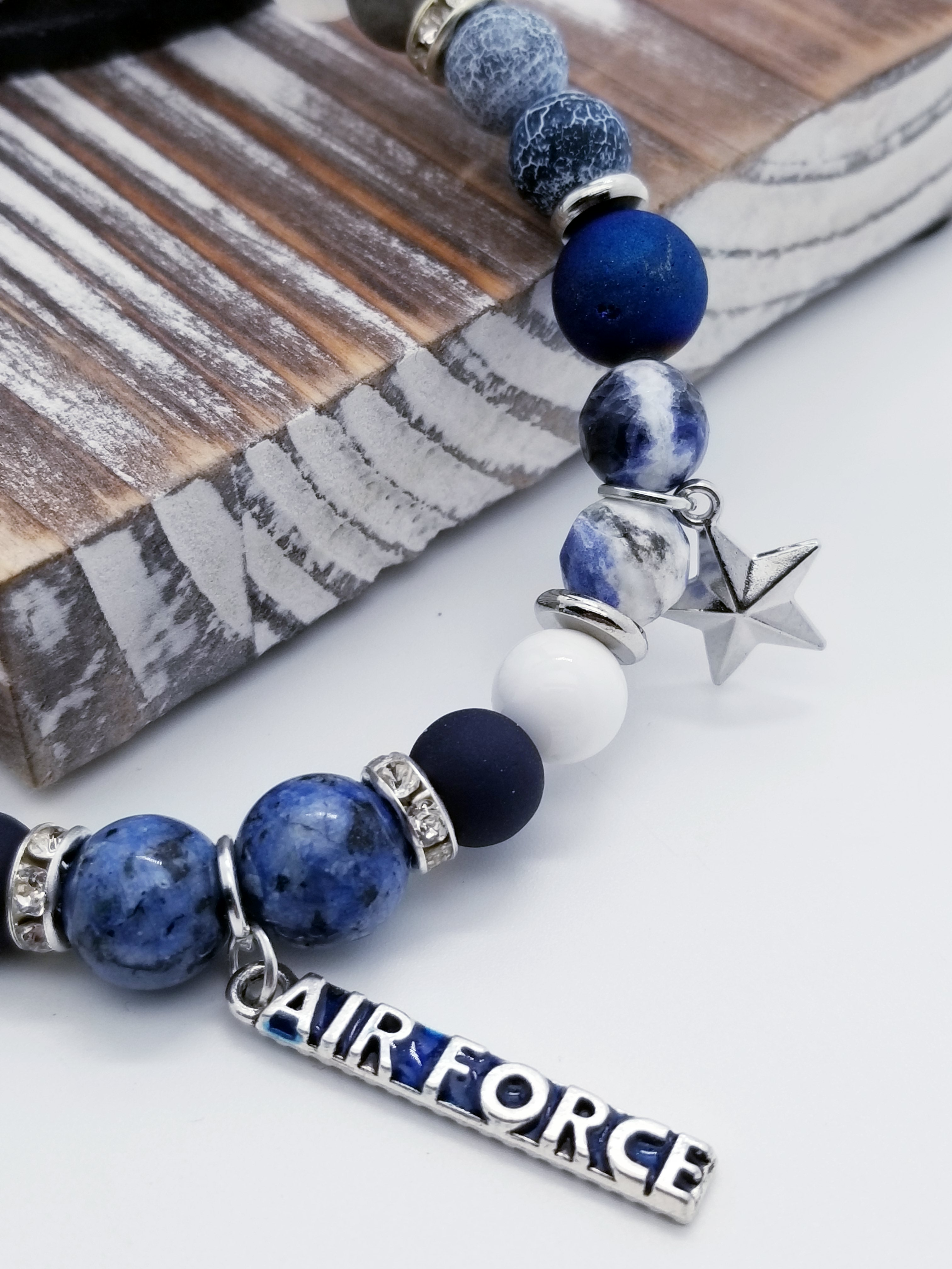 Integrity, Self Service, and Excellence (US Air Force core values) inspired bracelet to honor our troops, veterans, and the families that support them! "Air Force" and star charms with navy matte glass beads, white turquoise beads, indigo matte metallic beads, silver marbled glass beads, cracked navy and white glass beads, silver spacer beads, and grade A rondel (white rhinestone).